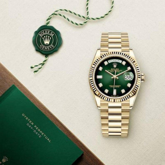 Rolex gold watch with green dial on a beige surface, accompanied by a green box and tag.